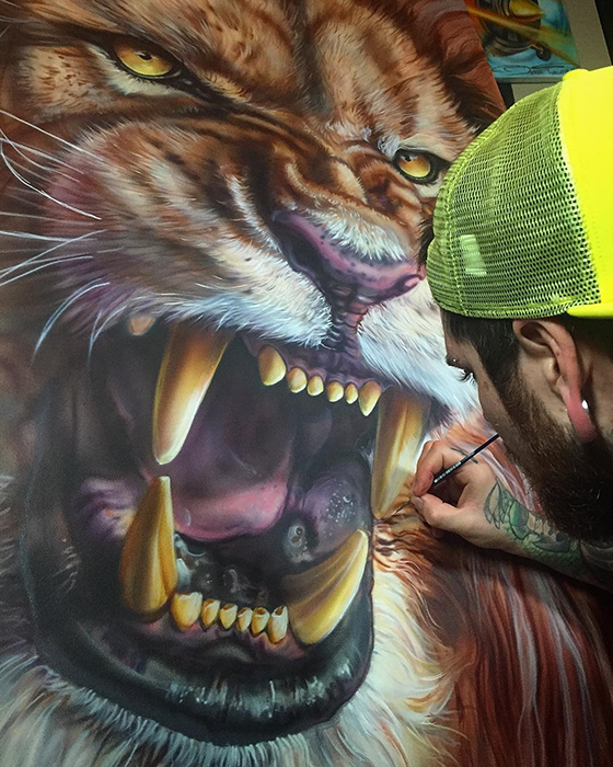 derek airbrush painting a lion head on a canvas